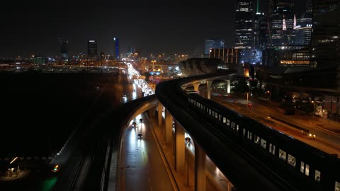Traffic in the city of Riyadh, drone footage of the high-speed train running on the railway, the architectural engineering art of modern-style towers and skyscrapers, buildings and economic facilities in the Kingdom of Saudi Arabia, modern transportation means.