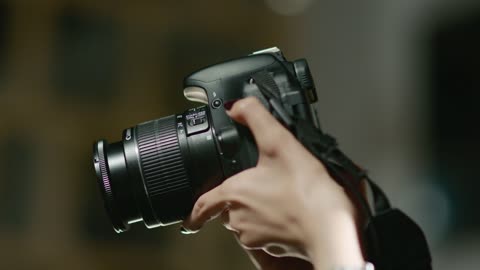 Mastering the art of photography, a professional Arab Gulf Saudi photographer captures artistic shots using a professional camera.