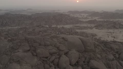 A rocky area in the Kingdom of Saudi Arabia, mountainous landscapes, drone photography of a mountain at sunset.