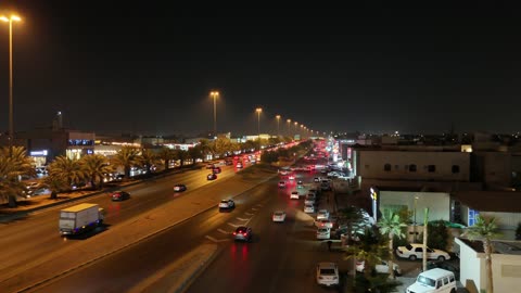 Traffic of cars on the roads at night in the Kingdom of Saudi Arabia, the interest in greening the city.