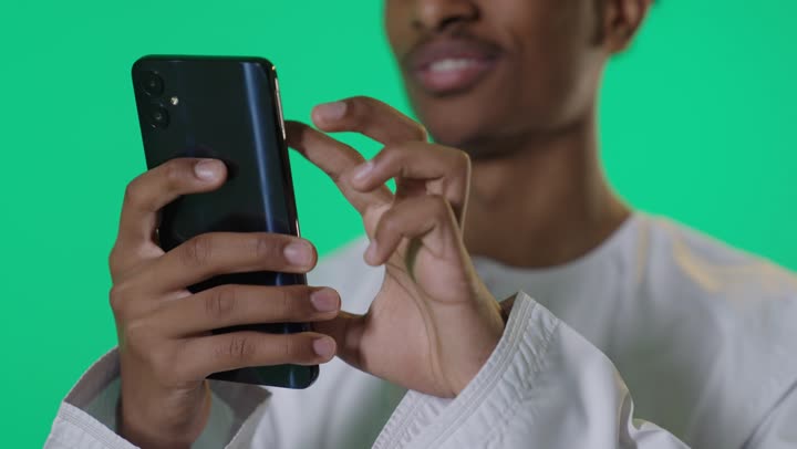 Khaleeji Man Using Smartphone on Green Screen Background