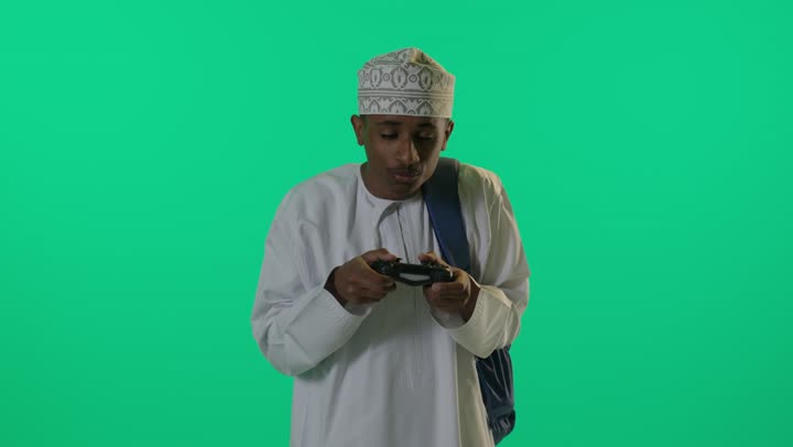 Omani Boy Playing Video Games on Green Screen