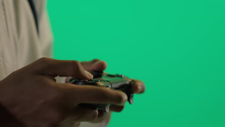 Arab Man Gaming with Controller on Green Screen