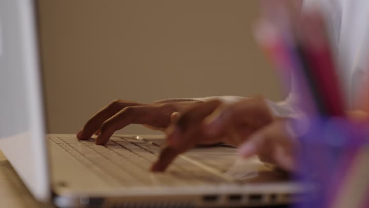 Saudi Man Typing on Laptop in Workspace Close Up