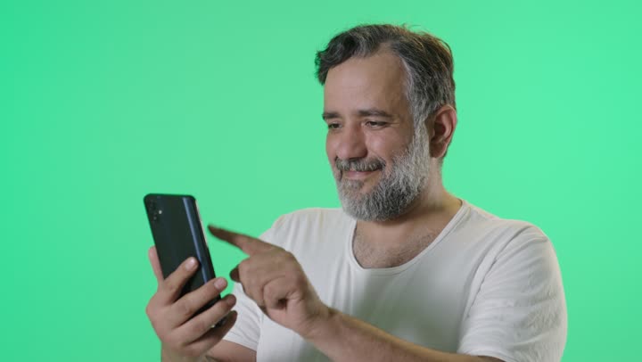 Man Using Smartphone on Green Screen Studio Background