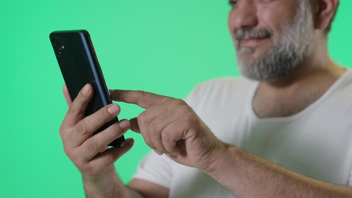 Arab Man Using Smartphone on Green Screen Background