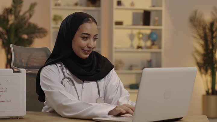 Saudi Female Doctor Working on Laptop in Home Office