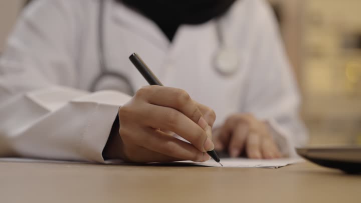 Saudi Female Doctor Writing Prescription Close Up