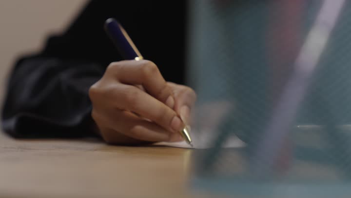 Saudi Woman Hand Writing on Paper Close Up