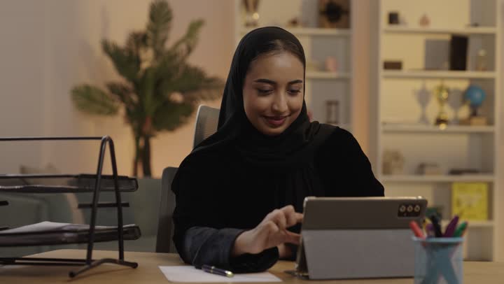 Saudi Woman Using Tablet in Home Office