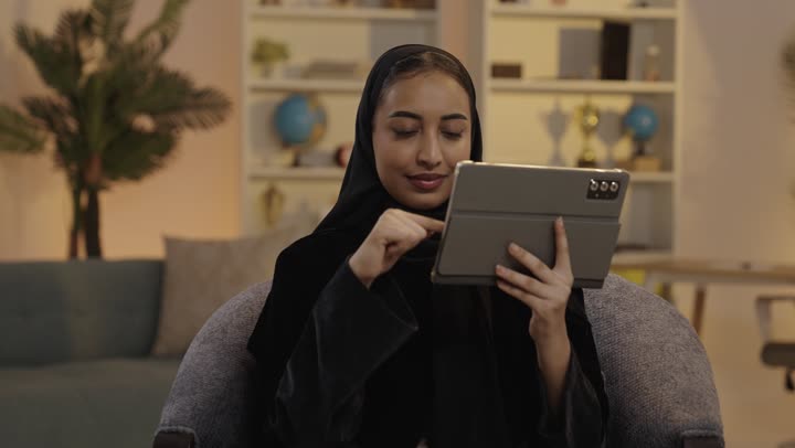 Saudi Woman Using Digital Tablet in Living Room