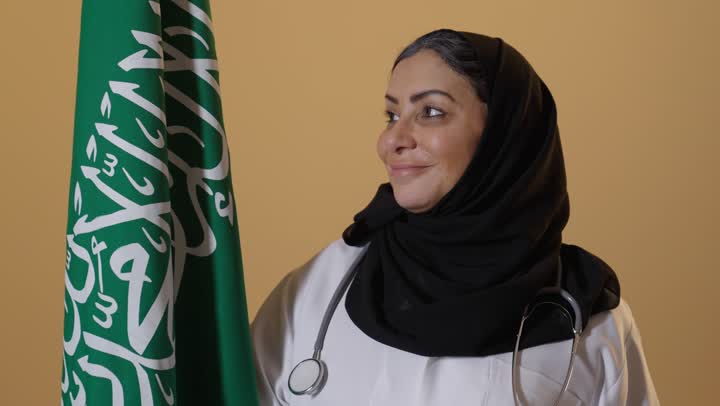 The logo of national identity and the banner of Islam and monotheism, celebrating Saudi National Day with pride and dignity, the anniversary of the founding of the first Saudi state on February 22, a portrait of an elderly Saudi Gulf Arab female doctor wearing a medical coat and stethoscope, with a beige background.