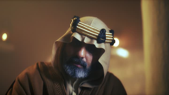 An elderly Arab Saudi Gulf man wearing a bisht and agal is reading an old historical book about Foundation Day, the anniversary of the establishment of the first Saudi state by Imam Muhammad bin Saud, which began on February 22, 1727. The pride in the nation's achievements and the realization of national identity.