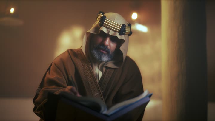 An elderly Arab Saudi Gulf man wearing a bisht and agal is reading an old historical book about Foundation Day, the anniversary of the establishment of the first Saudi state by Imam Muhammad bin Saud, which began on February 22, 1727. The pride in the nation's achievements and the realization of national identity.