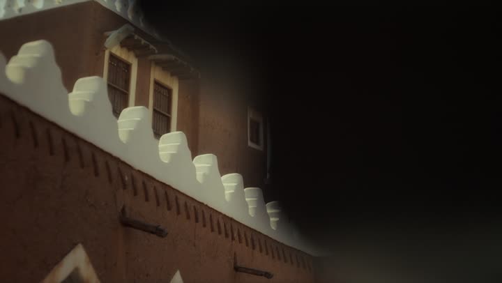 An elderly Saudi Arabian man, wearing a bisht and agal, stands in a traditional old mud-brick building on the anniversary of the founding of the first Saudi state by Imam Muhammad bin Saud, February 22, 1727. This day commemorates the nation's achievements and the realization of its national identity.