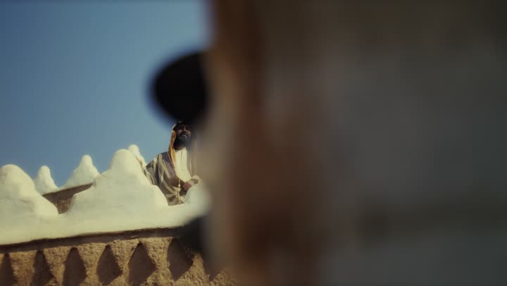 An elderly Saudi Arabian man, wearing a bisht and agal, stands in a traditional old mud-brick building on the anniversary of the founding of the first Saudi state by Imam Muhammad bin Saud, February 22, 1727. This day commemorates the nation's achievements and the realization of its national identity.