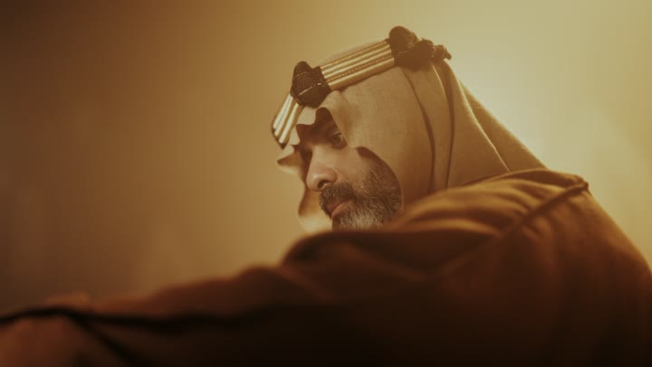 رجل كبير السن عربي سعودي خليجي يرتدي البشت وعقال يوم التأسيس تصوير من الجانب يقلب صفحات كتاب تاريخي, ذكرى تأسيس الدوله السعوديه الاولى على يد الامام محمد بن سعود, يوم بدينا 22 فبراير 1727م,  العمق التاريخي والحضاري للمملكة، ارتداء الأزياء التقليدية تعكس التراث