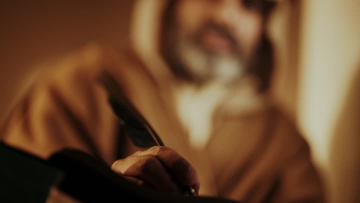 Wearing traditional attire reflects heritage. An elderly Arab Saudi Gulf man wearing a bisht and agal on Founding Day is writing a message on an old paper scroll, commemorating the establishment of the first Saudi state by Imam Muhammad bin Saud, on the day we began, February 22, 1727 AD, the historical and cultural depth of the Kingdom.