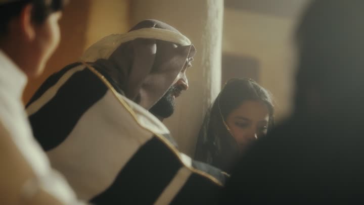 Sitting in one of the traditional mud houses, on the day we began in 1727 AD, telling a story to the children, the love among family members, the anniversary of the founding of the first Saudi state on February 22, an Arab Gulf Saudi man sitting with his children wearing traditional costumes during national holidays.