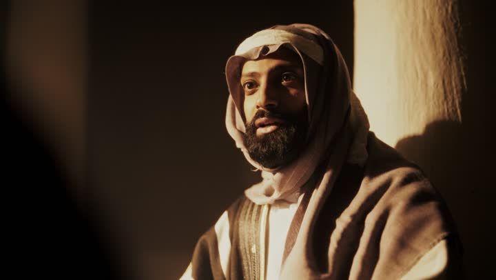 The love among family members, telling a story to the children, sitting in one of the traditional clay houses, on the day we started in 1727 AD, the anniversary of the founding of the first Saudi state on February 22, an Arab Gulf Saudi man sitting with his children wearing traditional costumes during national holidays.