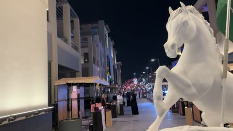 Saudi Flag Horse Sculpture at Night Outdoor Market