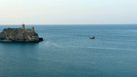 Traditional Dhow Sailing Past Oman Coastal Fort Footage