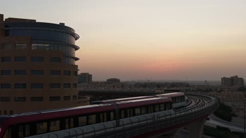 Modern Metro Train on Elevated Track at Sunset