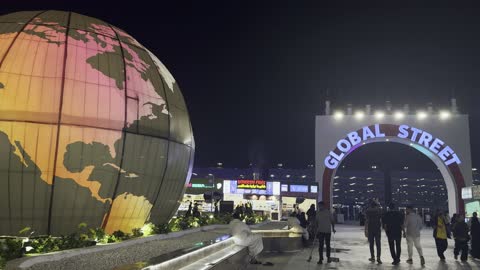Illuminated Globe Sculpture Global Street Night Panning Shot