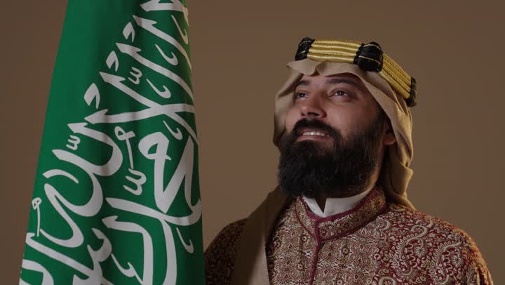 Saudi Man in Traditional Founding Day Dress with Flag