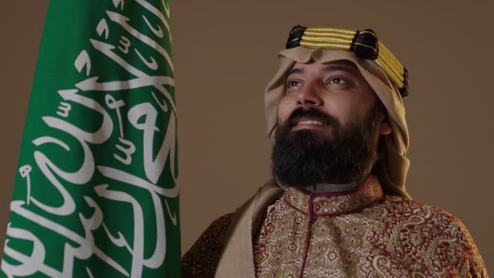 Saudi Man in Founding Day Attire with National Flag