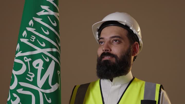 Saudi Engineer with National Flag Looking Upwards