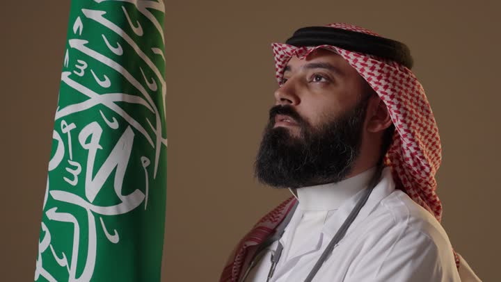 Saudi Doctor Standing by National Flag Founding Day