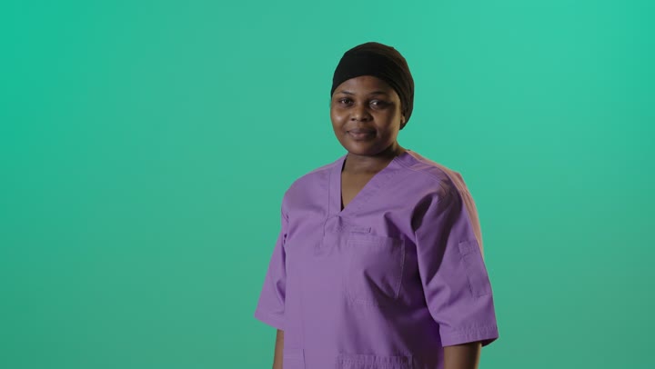 African Female Nurse in Purple Scrubs Green Screen