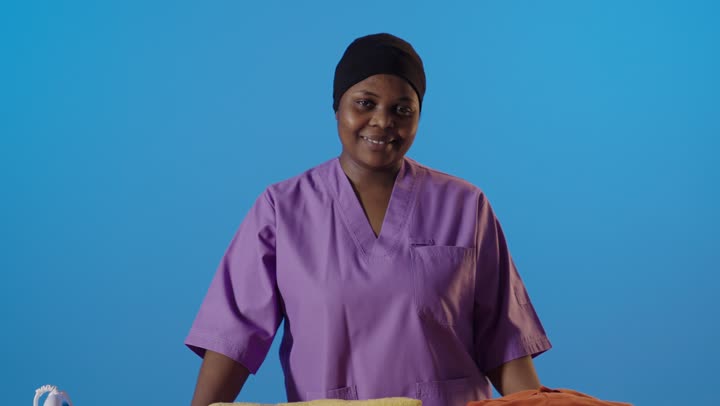 African Housekeeper Laundry Thumbs Up Blue Background