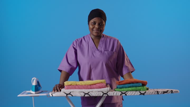 African Maid Giving Thumbs Up at Ironing Board