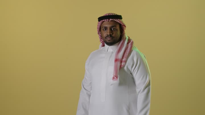 Saudi Man in Traditional Thobe on Yellow Background