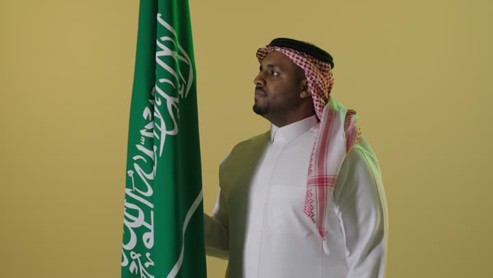 Saudi Man With National Flag In Studio Portrait