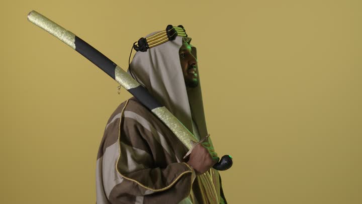 Saudi Man in Founding Day Attire Holding Sword Studio