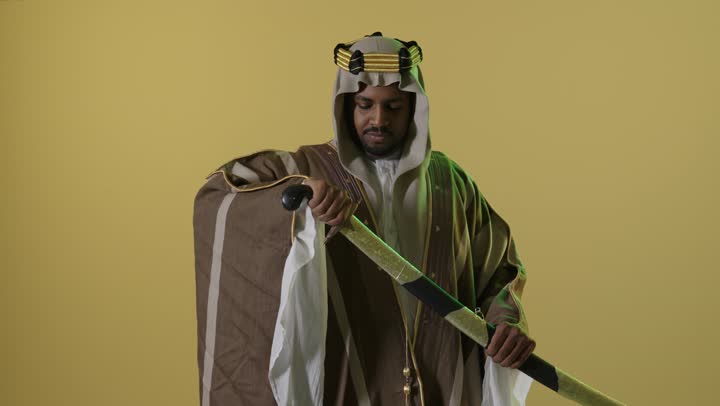 Saudi Man in Founding Day Attire Drawing Sword