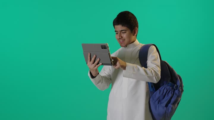 Saudi Schoolboy Using Tablet on Green Screen