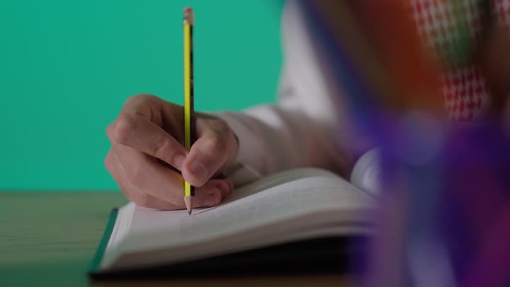 Saudi Man Writing in Notebook Green Screen Footage