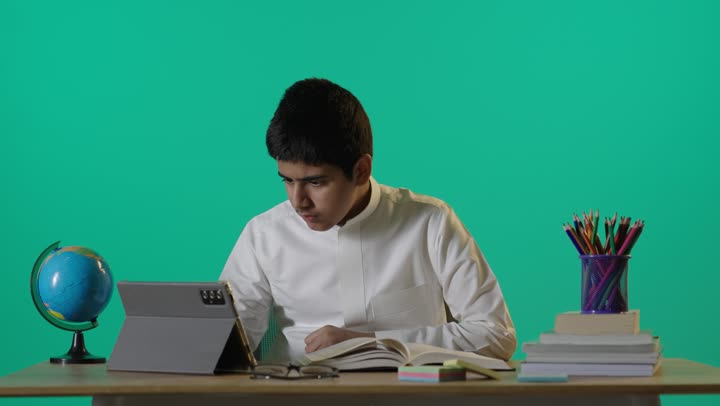 Saudi Boy Studying at Desk on Green Screen