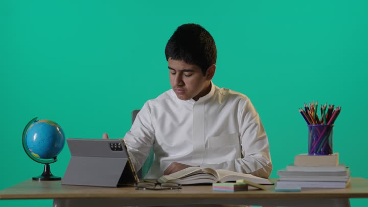 Saudi Student Studying at Desk on Green Screen