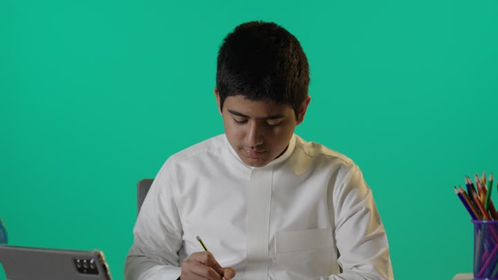 Saudi Boy Studying at Desk on Green Screen