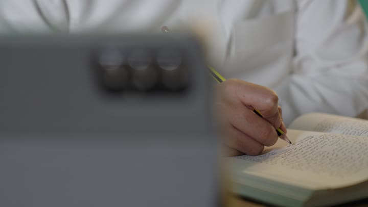 Saudi Student Writing in Notebook Close Up Footage