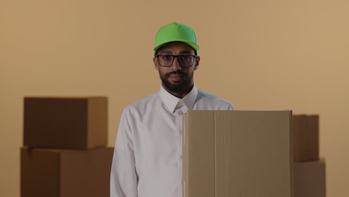 Saudi Man Giving Thumbs Down Holding Delivery Box