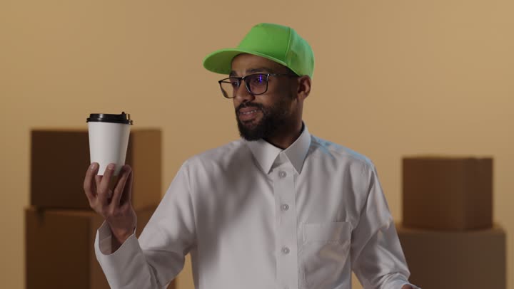 Saudi Delivery Man Holding Coffee and Shopping Bags