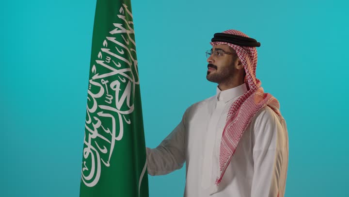 Saudi Man with National Flag on Blue Background