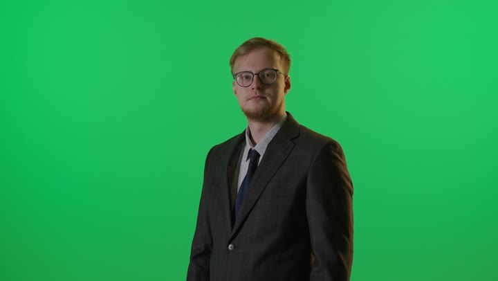 Businessman Standing on Green Screen with Crossed Arms