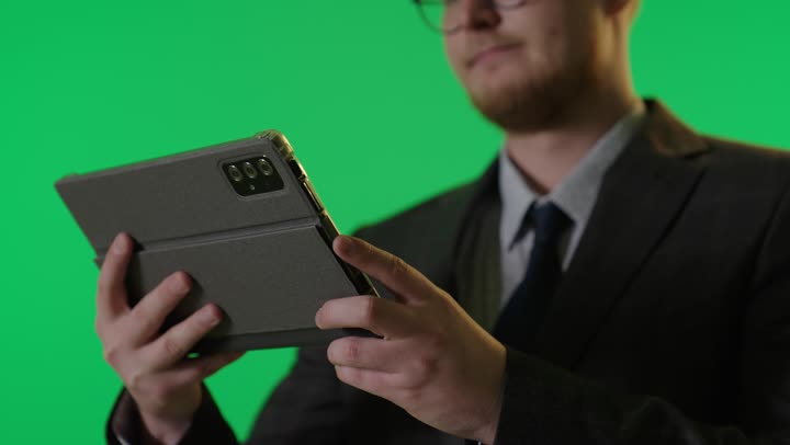 Businessman Using Tablet on Green Screen Background